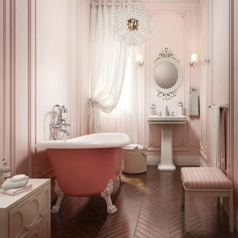 Stylish pink bathroom with freestanding tub, ornate mirror, elegant decor, showcasing sophisticated interior design.