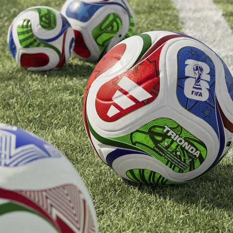 FIFA World Cup 26 Trionda Soccer Ball Size 4 With Hella Smooth Seamless TSBE Surface And Butyl Bladder For Superior Shape Retention And Dope Pro League Match Ready In White Royal Blue on grass.