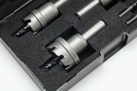 Angled top-front view of EZARC carbide hole saw kit, 3-piece set with pilot drill bits, stored in foam case