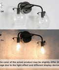 Two light black wall sconce with clear seeded glass globes shown illuminated and off on a white background.