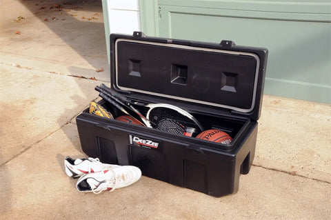 Beefy Poly Plastic Storage Chest With Double Wall Lid And Built In Cup Holders With Secure Locking Tabs For Truck Bed Hauling And Gear Stash Thirty Five Inch Organizer filled with sports equipment.