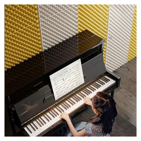 Girl playing piano in studio with Top Shelf 7cm Thick Egg Crate Acoustic Foam Roll for sound absorption on walls.