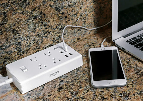 Eight International Adapters Travel Charging Station With Surge Protector And Four Smart USB Ports on granite surface