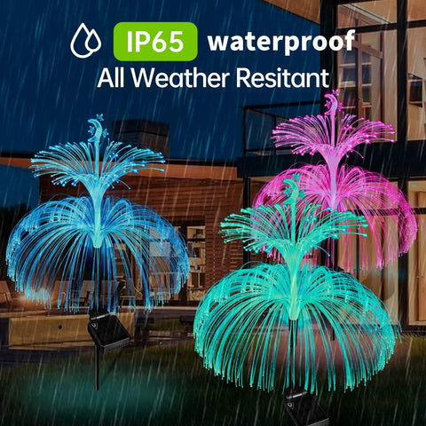 Lit Jellyfish Solar Lights Outdoor Garden 3 Pack Waterproof Color Changing with star and moon accents in rain.
