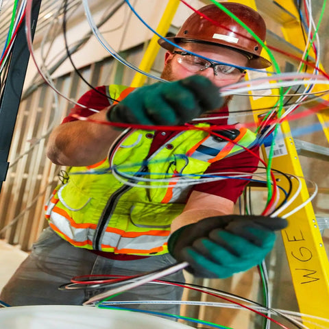 Worker installing Heavy Duty Building Wire Stranded Copper 12 Gauge 1 Conductor 20 Amp 600 Volt 90 Degree Celsius PVC Jacket
