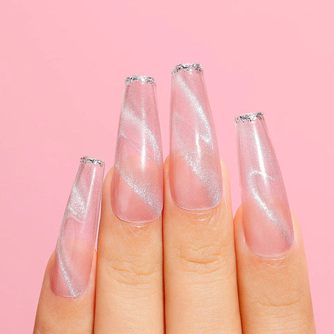 Shimmery nails featuring Cat Eye Gel Nail Polish Set HEMA Free Cruelty Free Vegan Soak Off UV LED Gel Manicure Kit For DIY Nail Art 6 Colors 10ml Bottles With Safe Formula And Long Lasting Shine on fingers against pink background.