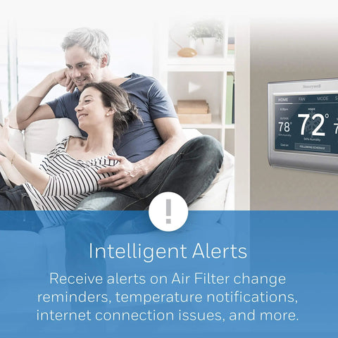 Couple on couch with WiFi Color Thermostat With 7 Day Programmable Schedule Touch Screen shown on wall, gray finish, smart alerts displayed.