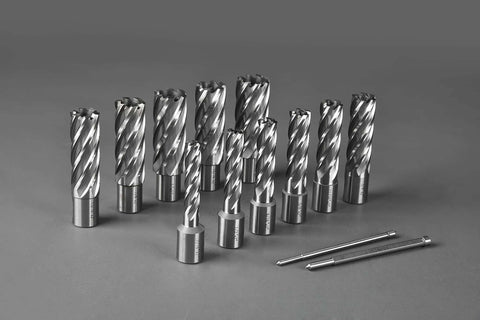 Front view of 13-piece annular cutter set with Weldon shanks, sizes 7/16 in to 1-1/16 in, plus two pilot pins