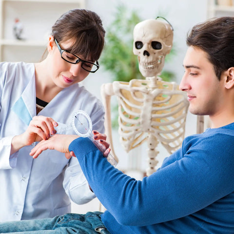 Physical therapist using Six Piece Spinal Goniometer Set With 360 Degree Protractor And Finger Goniometer on patient's wrist