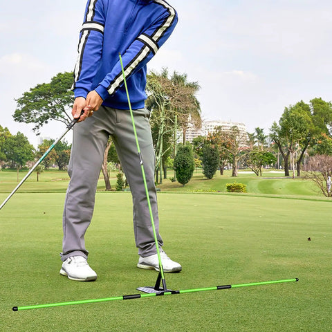 Golfer using Pro Grade Golf Swing Trainer with adjustable angle and red fiberglass rod for alignment on green course