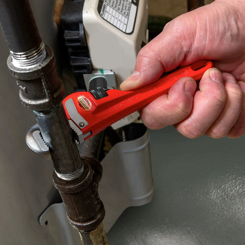 Heavy Duty 6 Inch Straight Pipe Wrench For Plumbing Projects With Serrated Steel Jaw And Cast Iron Handle Red Finish in use