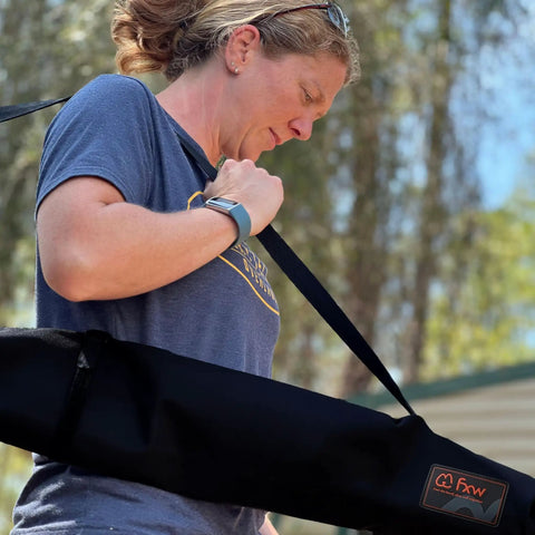Woman carrying Stakes Bag For Camping And Outdoor Use Stow And Carry Dog Pen Stakes With Ease Heavy Duty Travel Case