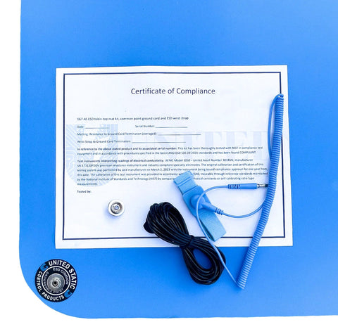 Front view of blue ESD mat kit with wrist strap, ground cord, and certificate of compliance.