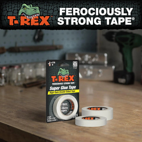 Heavy Duty Double Sided Super Glue Tape 0.75 Inches By 15 Yards Clear Acrylic Formula on wood table with two rolls and packaging.