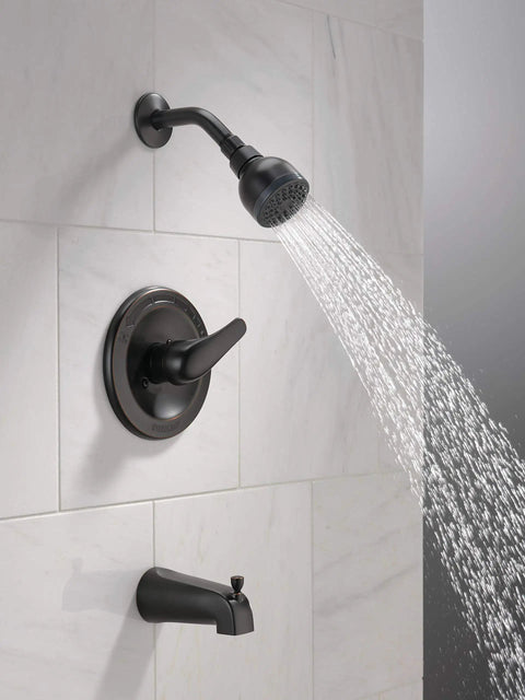 Single Handle Tub And Shower Faucet Trim Kit With Oil Rubbed Bronze Finish And Single Spray Touch Clean Shower Head PTT188750 OB Valve Not Included Easy Install For A Modern Bath installed on white tile wall