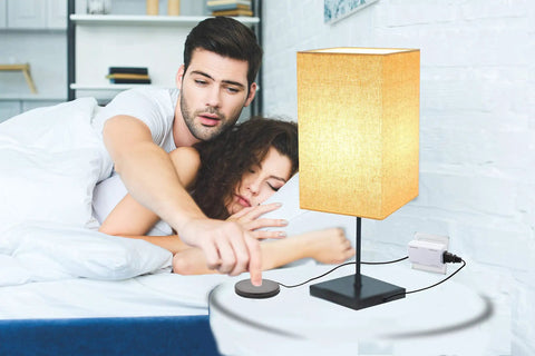 Man using Touch Pad Lamp Dimmer Switch With Three Levels Of Brightness For Table Floor And Desk Lamps No Fuss Plug In Cord Lighting Control Easy Install And Mood Lighting next to bed