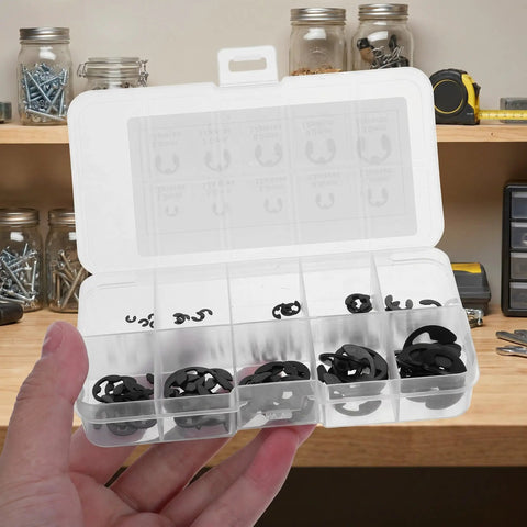 Hand holding 120 Piece E Clip Assortment Kit with 10 Sizes from 1.5mm to 10mm Black External Snap Rings in clear box