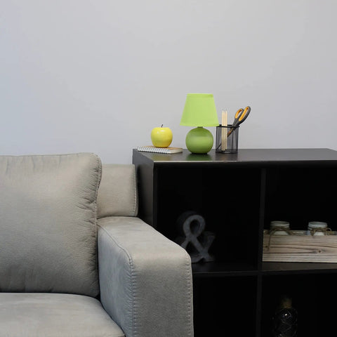 Yellow Mini Ceramic Globe Table Lamp With Matching Fabric Shade on a shelf beside a couch, 8.66 Inch Tall, Cozy Dorm Vibe