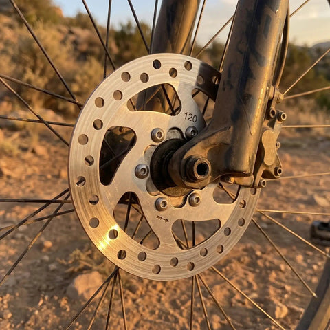120mm 6-Bolt Stainless Steel Brake Rotor for Electric Scooters and Mountain Bikes, Hollow Design, Installed on Bike Wheel