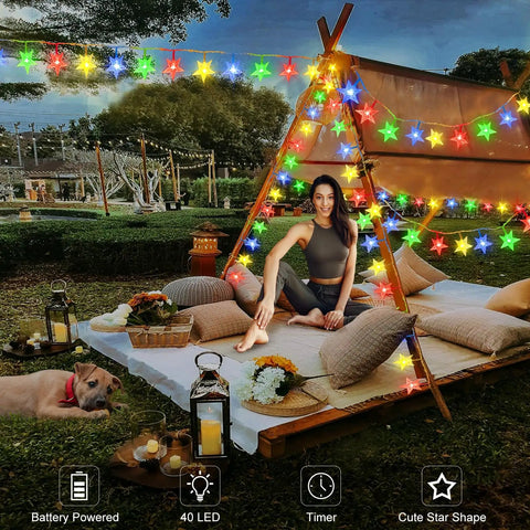 Outdoor scene with woman sitting by tent decorated with Star Shaped String Lights Battery Powered 13ft 40LED Fairy Lights