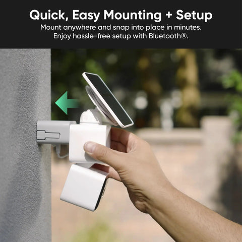Hand mounting No Sweat Solar Security Camera with solar panel on a wall for easy installation, showcases battery-powered setup.
