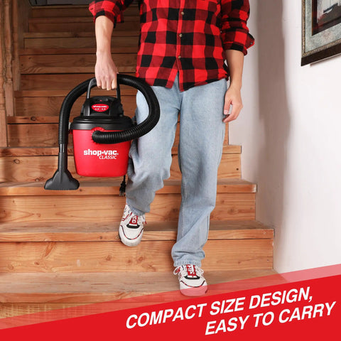 Person carrying 2.5 Gallon 2.5 Peak HP Wet Dry Vacuum Portable Compact Shop Vacuum With Collapsible Handle down stairs