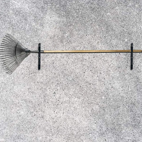 Two Pack Heavy Duty Black Aluminum Pool Pole Hangers With Screws Sturdy Hooks installed holding a rake on a wall