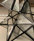 Close-up of 14 Inch Star Pendant Light With Seeded Glass Shade showing bulb installation point, handcrafted modern star lighting.