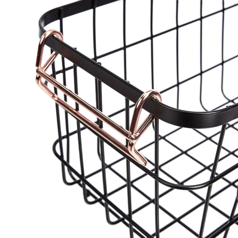 Close-up of a Real Deal Stackable Metal Wire Storage Basket With Rose Gold Handles, showcasing the sturdy black steel frame.