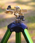 Brass nozzle on green tripod from 2 Pack Impact Sprinklers On Tripod Bases With Stakes 360 Degree Coverage Irrigation System