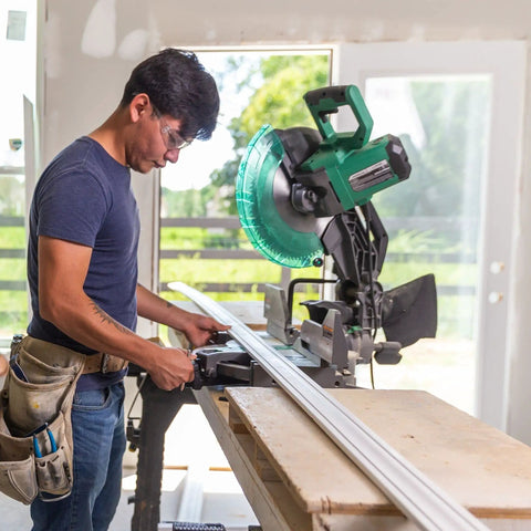 Person using 12-Inch Compound Miter Saw With Xact Cut LED Shadow Line System And Dual Bevel, 15 Amp Motor for woodworking.