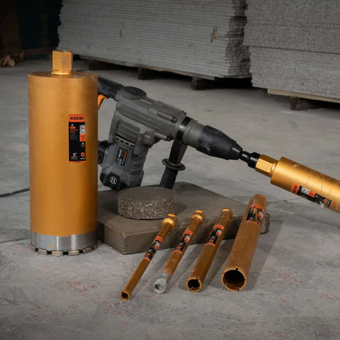 KSEIBI wet core drill bits set with orange bits and a gray hammer drill on concrete