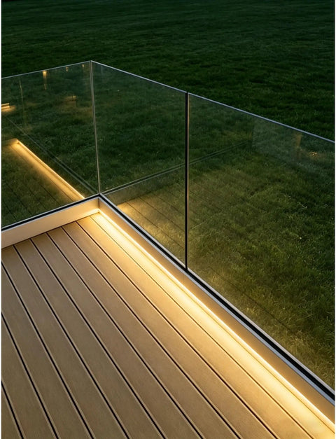 Adjustable Aluminum Glass Spigot Kit Built Tough For Decks And Pools installed on a patio with tempered glass panels and LED lighting.