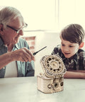 3D Wooden Puzzle Password Box Kit For Adults And Teens With A Hidden Combination Lock Mechanism Laser Cut Wood No Glue Required Clear Instructions: man and boy assembling wooden puzzle box