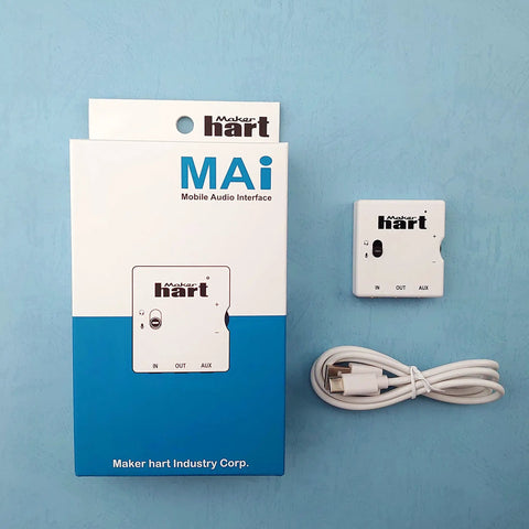 MAI Mini Mobile Audio Interface With Zero Latency Monitoring And High Fidelity Headphone Output next to its packaging and cable.