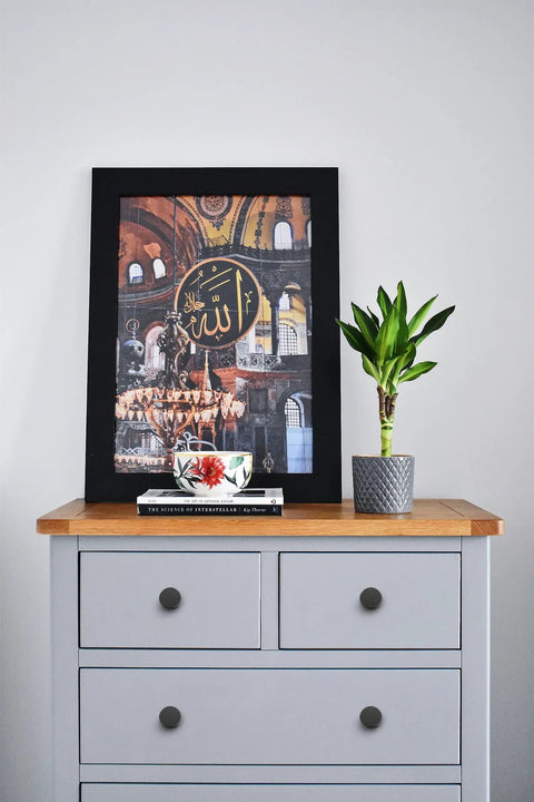 Framed art and plant on dresser with matte black kitchen cabinet knobs, showcasing Euro style hardware 3/4 inch round drawer pulls.