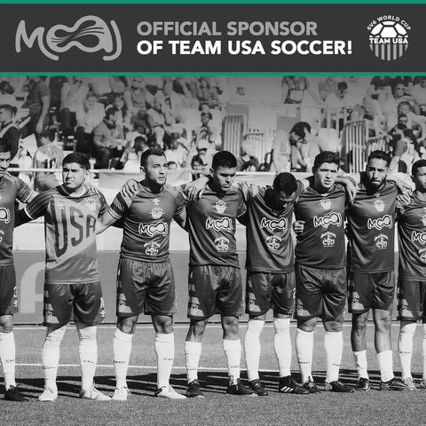Soccer team in uniform standing together on field, sponsored by company logo visible above.