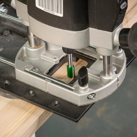 Close-up of Rock Solid Trim Base For Hardwood Lipping Quick Swap Router Adapter attached to a router for precise edge trimming.