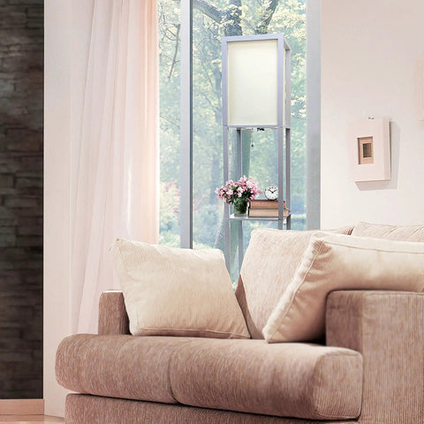 Sleek Gray Etagere Floor Lamp With Linen Shade And Built-In Shelves next to beige sofa in a bright living room with decorative items.