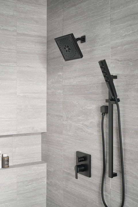 Angular Modern Shower Trim Kit Knockout Matte Black Integrated Diverter with rain showerhead in modern bathroom setting.