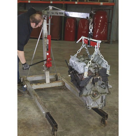 Heavy Duty 8 Ton Long Ram Hydraulic Floor Jack With Rapid Double Piston Pump For Smooth Car Raising Features Clevis Base in use lifting engine.