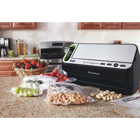 Heavy Duty 2 In 1 Vacuum Sealer Machine With Automatic Bag Detection And Starter Kit next to sealed bags of fruit and nuts.