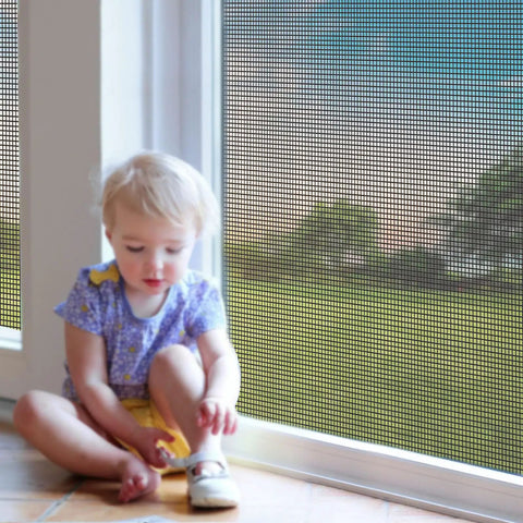 Child sitting beside a window with DIY Window Screen Replacement Mesh For Windows Doors And Patio, Adjustable Fiberglass Screen Roll