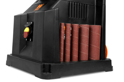Close-up of oscillating spindle sander with five sanding sleeves onboard, showcasing the Oscillating Spindle Sander With a Beefy Beveling Table Top, 3.5 Amp Motor, 2000 RPM, 58 Stroke Per Minute, Five Sanding Sleeve Sizes From Half Inch To Two Inches, Onboard Storage, And A Big 14 By 14 Inch Table.
