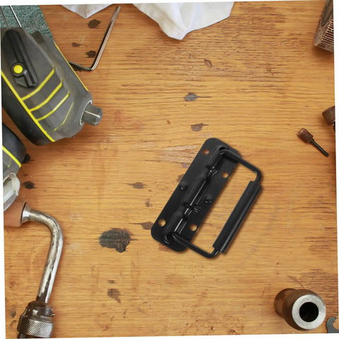 Heavy Duty Stainless Steel Spring Folding Chest Handle For Toolbox Replacement Featuring A Heck Of A Grip And Awesome Quick Setup In Premium Classic Matte Black on a wooden surface.