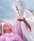 Adults wearing Four Pack Disposable Rain Ponchos With Hood For Adults Clear See Through Emergency Rain Gear Lightweight And Waterproof