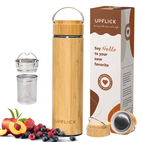 Premium 17 Oz Bamboo Tea Tumbler With Removable Loose Leaf Infuser next to fresh fruit and metallic infusers, showcasing eco-friendly design.