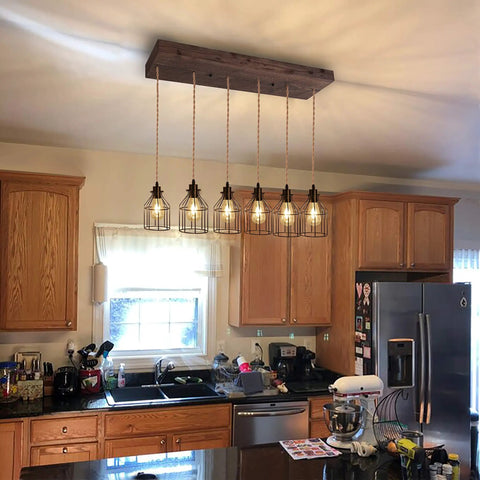 Six Light Wood Pendant Light for Kitchen Island With Industrial Black Metal Cage Shades in kitchen setting
