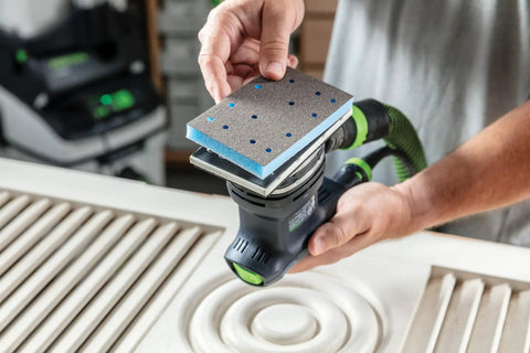 Person using Foam Back Contouring Abrasive Discs With Hook And Loop Mount For Precise Detail Sanding And Contour Work on wood surface