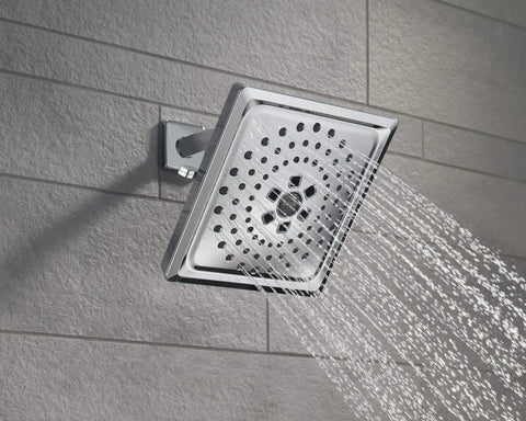 3-Setting Chrome Rain Shower Head With H2Okinetic Spray, 7.5 Inch Square, displaying water flow against wall